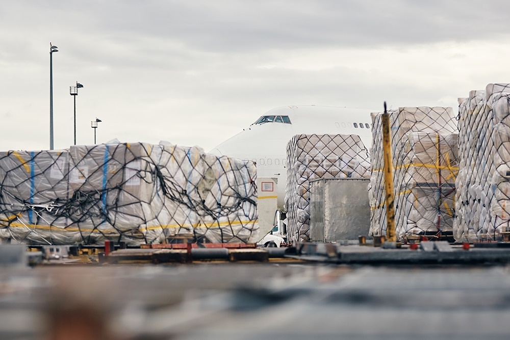 Loading of cargo containers to plane at airport